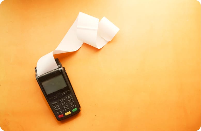 A card terminal printing a long receipt